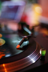 DJ turntable playing vinyl record with music on hip hop party in night club. Professional disc...