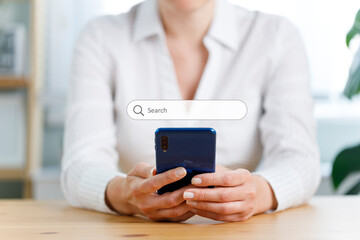 Businesswoman touching on smartphone for input wording and searching from web browser