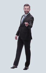 full length .smiling handsome businessman pointing at you