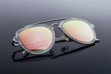trendy chameleon sunglasses on a black background. style and vision protection fashion accessory © Vladimir Razgulyaev