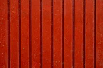 A close-up of a roughly painted wooden plank fence.