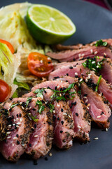 Juicy steak medium rare beef with green salad on plate