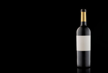A bottle of wine with a beautiful highlight and gradient on a black empty background