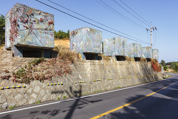 Anti-tank concrete blocks (barricades) on a roadside close to the Demilitarized zone (DMZ), between North Korea and South Korea