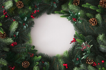 Fototapeta na wymiar Creative flat lay Christmas background made of fir branches like frame. Nature New Year concept.