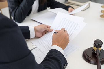 Judge gavel with Justice lawyers having team meeting at law firm background. Concepts of Law and Legal services.