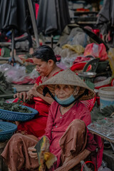 Portrait of Vietnamese woman. Elderly woman selling in the traditional market. Seller. travel to asia
