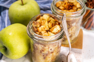Apple pie mugcake in glass jar, Simple quick apple pie cinnamon cake recipe in microwave, on white background copy space
