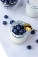 Homemade yogurt with blueberries. Top view on the white table