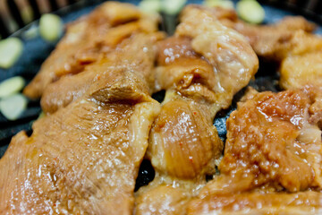 Jeju Black Pig meat grilling on an iron plate, close-up view, restaurant in Jejudo (Jeju Island), South Korea
