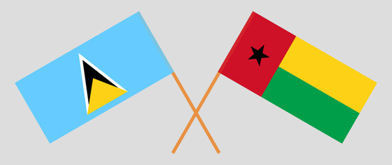 Crossed flags of Saint Lucia and Guinea-Bissau. Official colors. Correct proportion