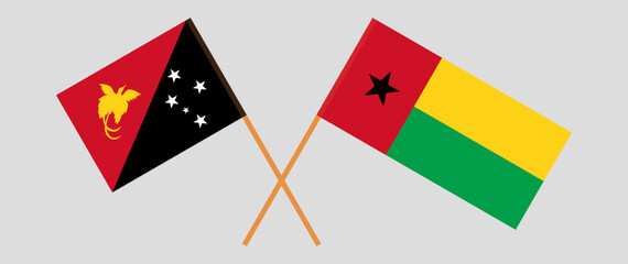 Crossed flags of Papua New Guinea and Guinea-Bissau. Official colors. Correct proportion