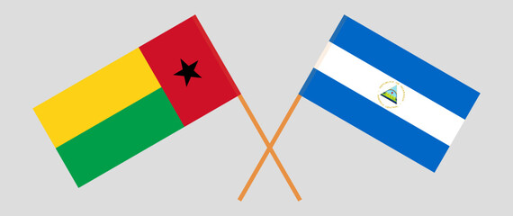 Crossed flags of Guinea-Bissau and Nicaragua. Official colors. Correct proportion