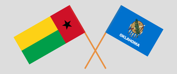 Crossed flags of Guinea-Bissau and The State of Oklahoma. Official colors. Correct proportion