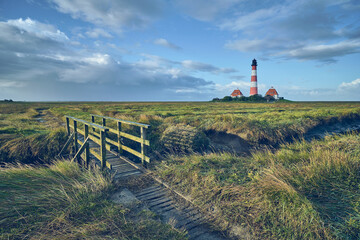 Fototapeta na wymiar Lighthouse Westerheversand at German north sea coast. High quality photo