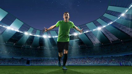 Fototapeta na wymiar Winner emotions. Excited soccer player running at the crowded stadium with spot lights during evening football match. Concept of sport, competition, championship