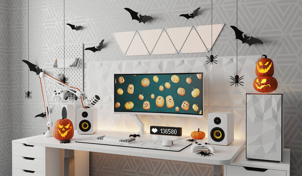 A general view of a gamer's home workplace with a computer and a gamepad decorated with decorations for the Halloween holiday.