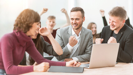 happy team of employees sitting at the office Desk