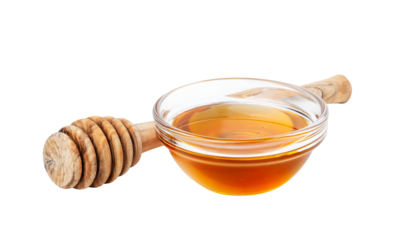 Glass bowl with honey and wood honey dipper isolated.