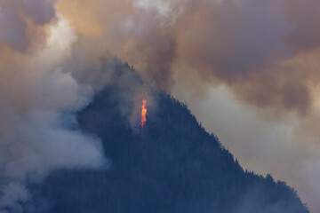 BC Forest Fire and Smoke over the mountain near Hope during a hot sunny summer day. British Columbia, Canada. Wildfire natural disaster