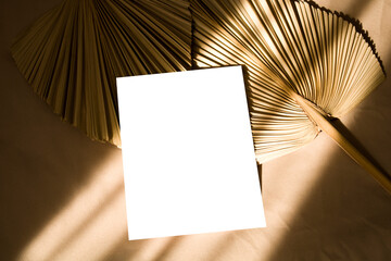 5x7 card mockup with sunlight shadows and dry palm leaf
