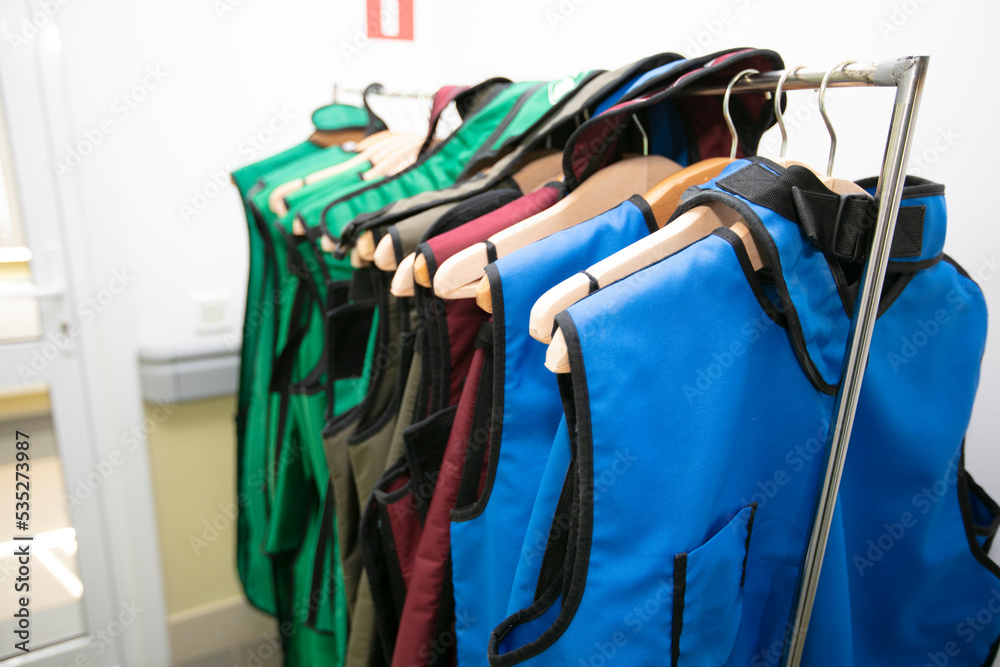 Wall mural rack of lead aprons used for x-ray protection in operating room, hospital