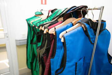 Rack of lead aprons used for x-ray protection in operating room, hospital