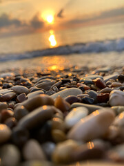 Obraz premium View of the sea and sun rising above the stones in Cirali, Antalya, Turkey. Selective focus.