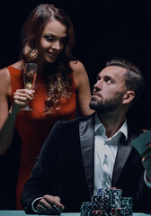 Young people playing poker at the table.