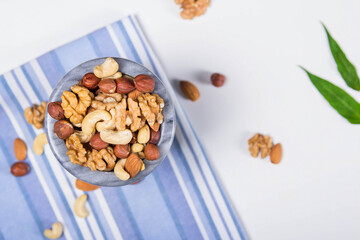 Marble bowl filled with shelled almonds, walnuts, cashew nuts