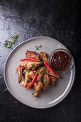 Barbecue chicken wings with sauce on black table