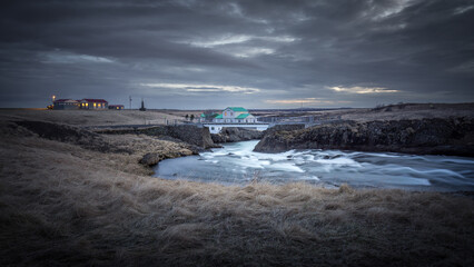 Small house standing on a bridge over the river