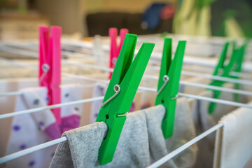 Colorful clothespins on a drying rack