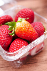  Ripe Red Strawberries in a plastic packet on table 
