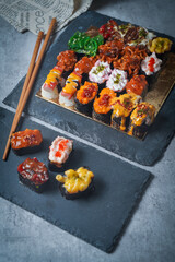 Sushi is a Japanese dish of prepared vinegared rice (鮨飯, sushi-meshi), usually with some sugar and salt, accompanied by a variety of ingredients