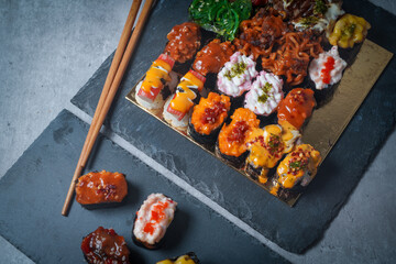 Sushi is a Japanese dish of prepared vinegared rice (鮨飯, sushi-meshi), usually with some sugar and salt, accompanied by a variety of ingredients