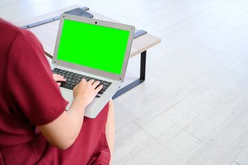 Manager woman working at mockup green screen chroma key laptop with isolated display. businesswoman...