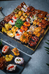 Sushi is a Japanese dish of prepared vinegared rice (鮨飯, sushi-meshi), usually with some sugar and salt, accompanied by a variety of ingredients