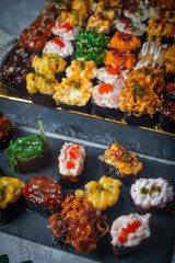 Sushi is a Japanese dish of prepared vinegared rice (鮨飯, sushi-meshi), usually with some sugar and salt, accompanied by a variety of ingredients