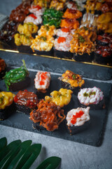 Sushi is a Japanese dish of prepared vinegared rice (鮨飯, sushi-meshi), usually with some sugar and salt, accompanied by a variety of ingredients