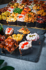 Sushi is a Japanese dish of prepared vinegared rice (鮨飯, sushi-meshi), usually with some sugar and salt, accompanied by a variety of ingredients