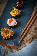 Sushi is a Japanese dish of prepared vinegared rice (鮨飯, sushi-meshi), usually with some sugar and salt, accompanied by a variety of ingredients