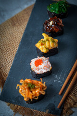 Sushi is a Japanese dish of prepared vinegared rice (鮨飯, sushi-meshi), usually with some sugar and salt, accompanied by a variety of ingredients