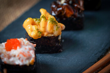 Sushi is a Japanese dish of prepared vinegared rice (鮨飯, sushi-meshi), usually with some sugar and salt, accompanied by a variety of ingredients