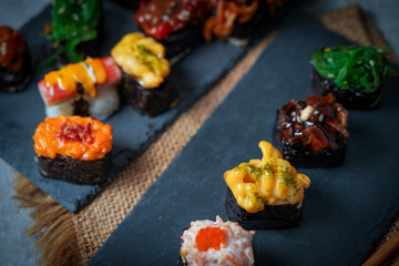 Sushi is a Japanese dish of prepared vinegared rice (鮨飯, sushi-meshi), usually with some sugar and salt, accompanied by a variety of ingredients