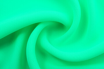 Fabric chintz, satin, green silk with folds and wrinkling. Aquamarine fabric texture