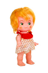 Plastic and rubber isolated vintage doll in a red and white polka dot dress and orange red hair with freckles