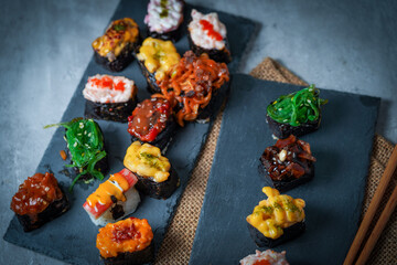 Sushi is a Japanese dish of prepared vinegared rice (鮨飯, sushi-meshi), usually with some sugar and salt, accompanied by a variety of ingredients