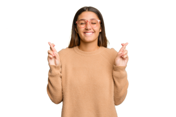 Young Indian woman isolated cutout removal background crossing fingers for having luck