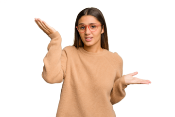 Young Indian woman isolated cutout removal background confused and doubtful shrugging shoulders to hold a copy space.